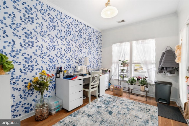 office space with crown molding and light wood-type flooring