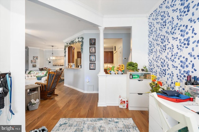 interior space featuring ornamental molding, light hardwood / wood-style flooring, and decorative columns