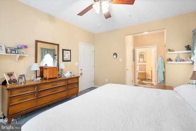 carpeted bedroom with ensuite bath and ceiling fan