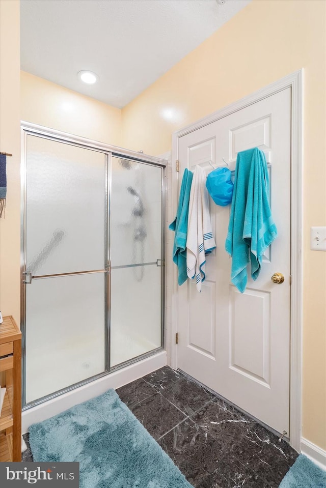 bathroom with a shower with shower door