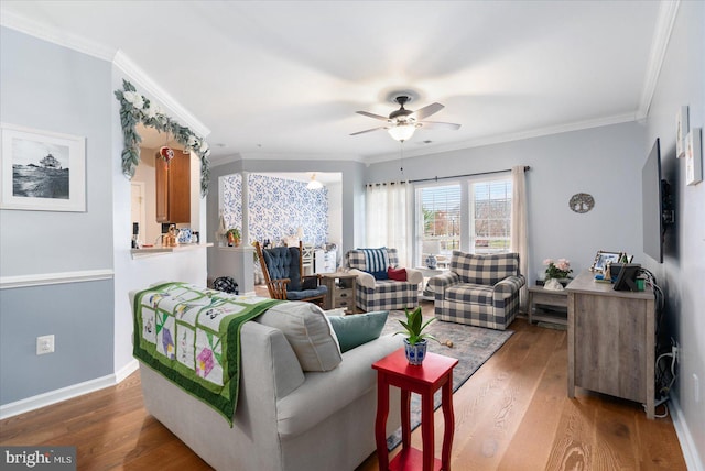 living room featuring crown molding, ceiling fan, and dark hardwood / wood-style flooring