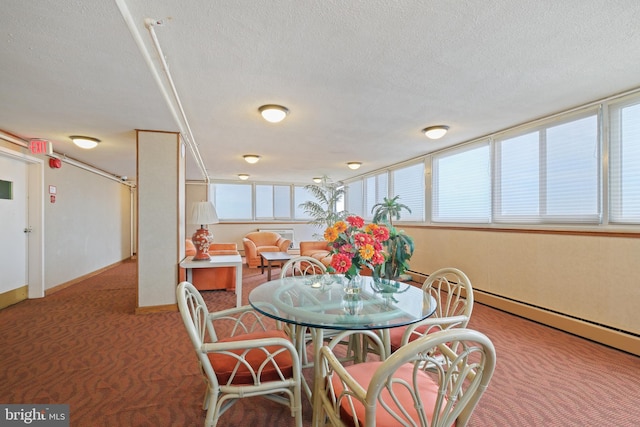 dining space with carpet flooring and a textured ceiling