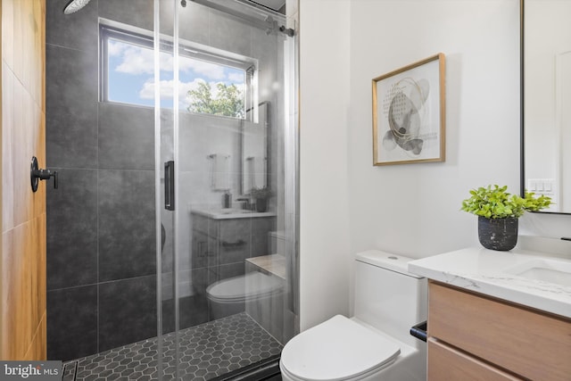 full bath featuring toilet, a shower stall, and vanity