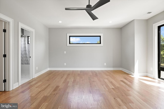 empty room with plenty of natural light, light hardwood / wood-style floors, and ceiling fan