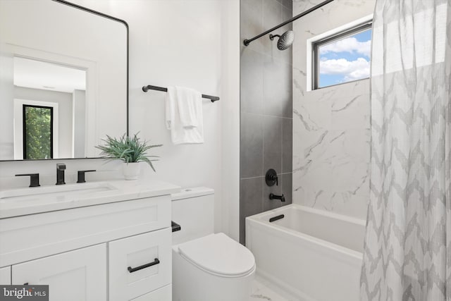 bathroom with shower / bath combo with shower curtain, toilet, marble finish floor, and vanity