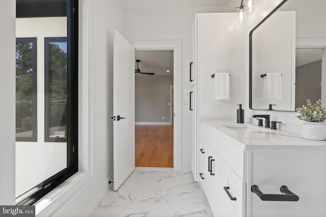 bathroom featuring ceiling fan, vanity, and wood-type flooring