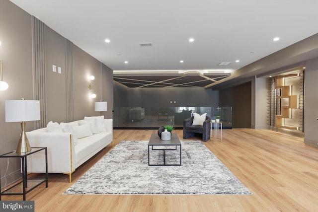 living room with visible vents, recessed lighting, and wood finished floors