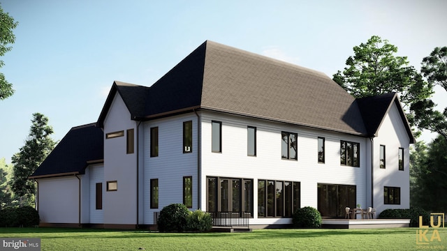 rear view of property with a lawn and roof with shingles