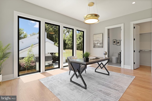 office space featuring recessed lighting, light wood-style flooring, and baseboards