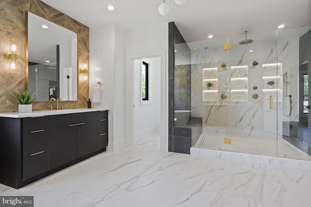 full bath featuring a marble finish shower, recessed lighting, marble finish floor, and a wealth of natural light