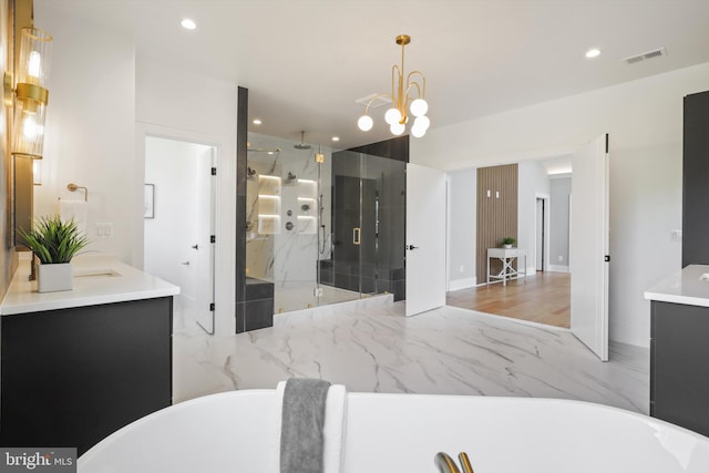 bathroom with visible vents, a shower stall, a soaking tub, marble finish floor, and vanity