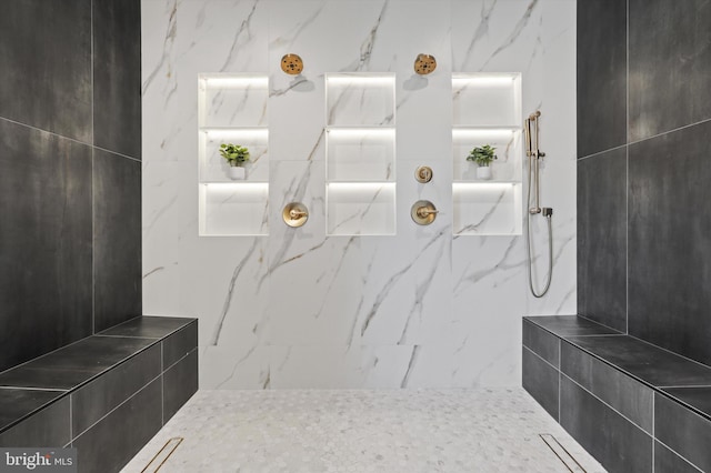 bathroom with a marble finish shower