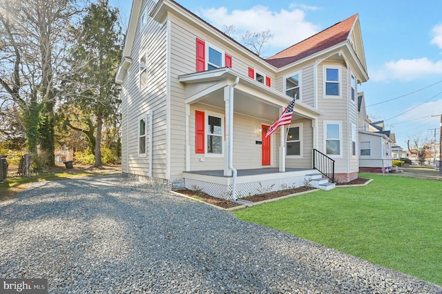 view of front facade featuring covered porch, central air condition unit, and a front yard