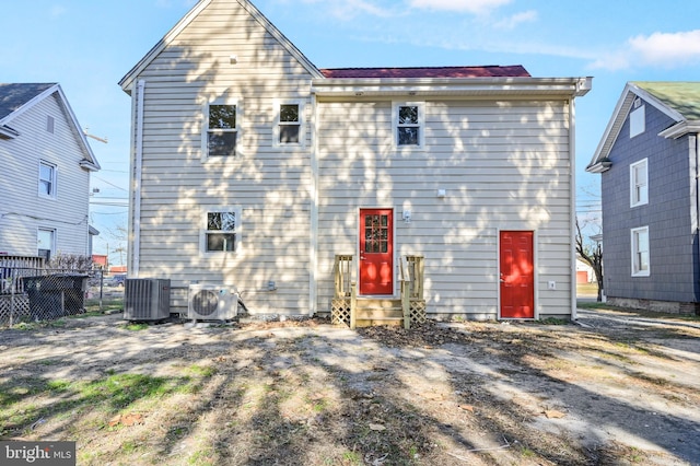 rear view of house featuring central air condition unit