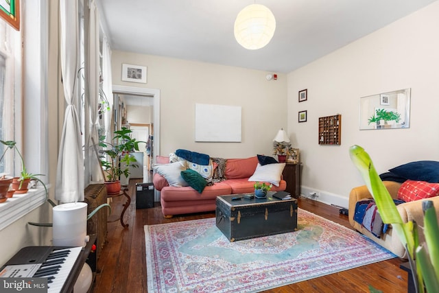 living room with wood finished floors and baseboards