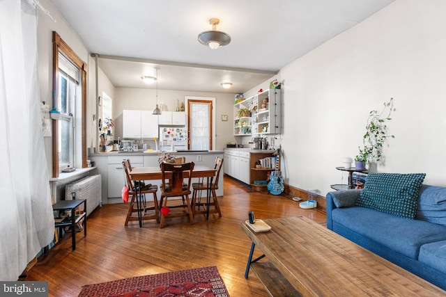 dining room featuring radiator and wood finished floors