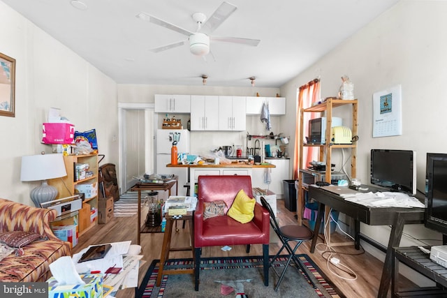 interior space featuring ceiling fan and wood finished floors