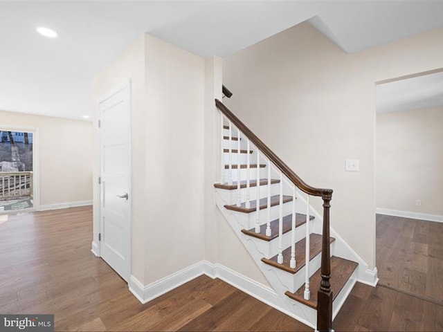 stairs featuring recessed lighting, wood finished floors, and baseboards