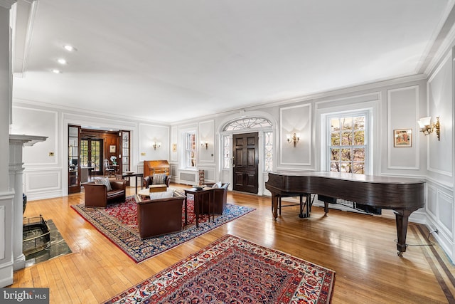 living room with a decorative wall and light wood-style flooring