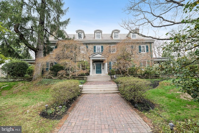 colonial home featuring stone siding