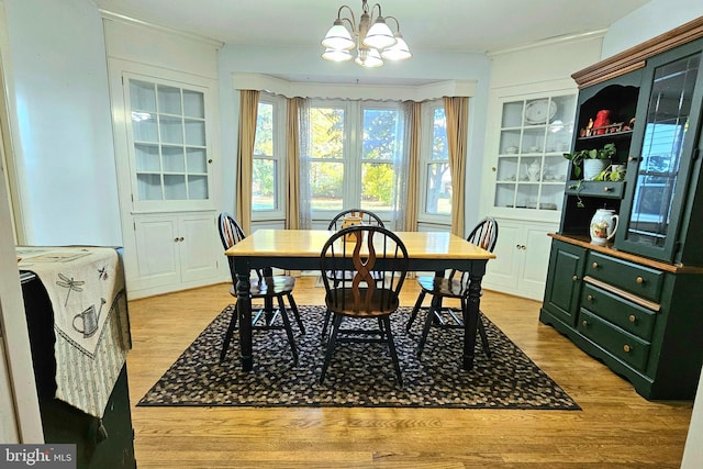 dining room featuring a chandelier and light wood-type flooring