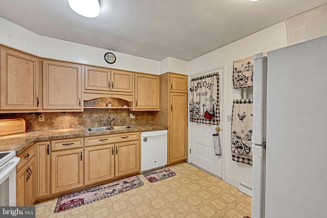 kitchen featuring white appliances, sink, and tasteful backsplash