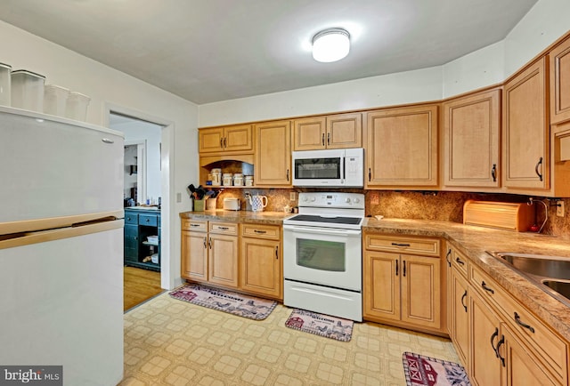 kitchen with white appliances and backsplash