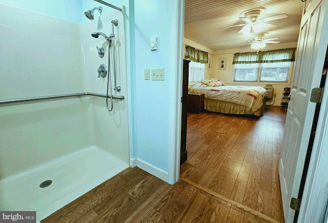 bathroom featuring hardwood / wood-style floors, ceiling fan, and a shower