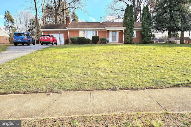 ranch-style house with a garage and a front yard