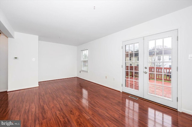 unfurnished room featuring hardwood / wood-style floors and french doors