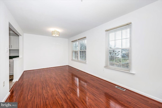 unfurnished room with hardwood / wood-style floors