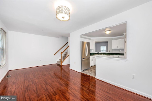 unfurnished living room with dark hardwood / wood-style floors and sink