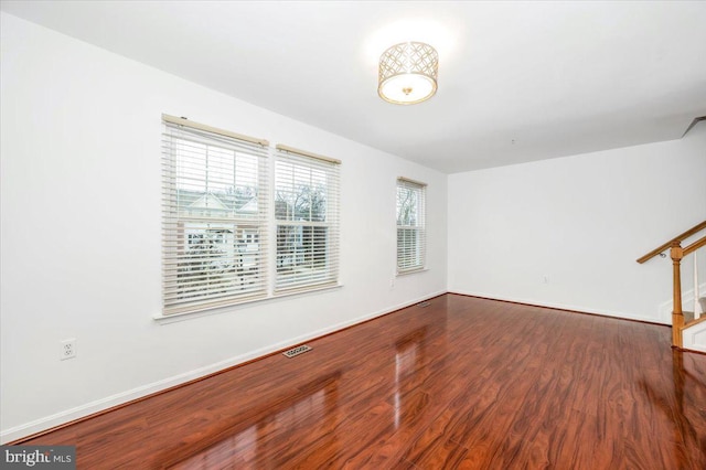 unfurnished room featuring plenty of natural light and hardwood / wood-style flooring