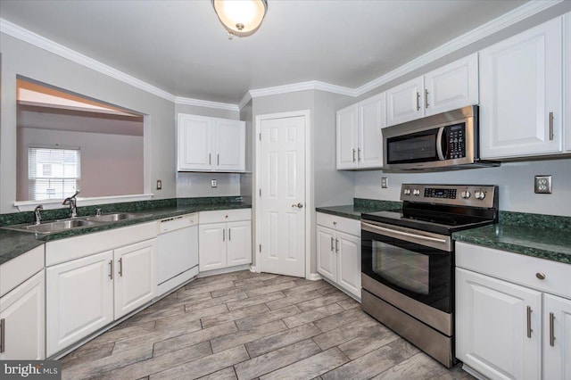 kitchen with crown molding, white cabinetry, sink, and appliances with stainless steel finishes