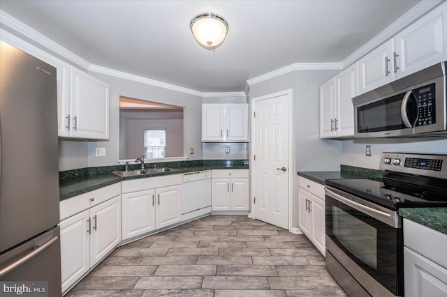 kitchen with appliances with stainless steel finishes, crown molding, sink, light hardwood / wood-style floors, and white cabinetry