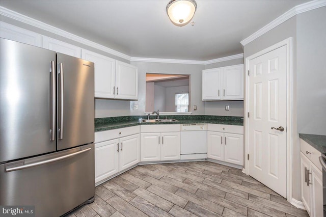 kitchen featuring dishwasher, white cabinets, sink, stainless steel fridge, and light wood-type flooring