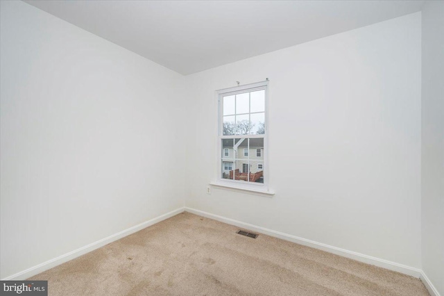 unfurnished room with light colored carpet