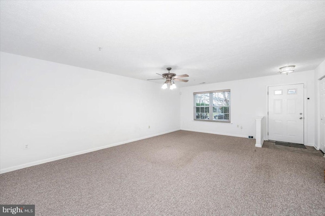 unfurnished living room with carpet, a textured ceiling, and ceiling fan