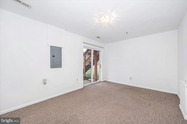 carpeted spare room featuring electric panel