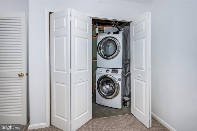 laundry area featuring stacked washing maching and dryer and light colored carpet