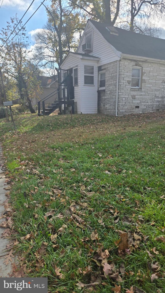 view of side of property with a lawn