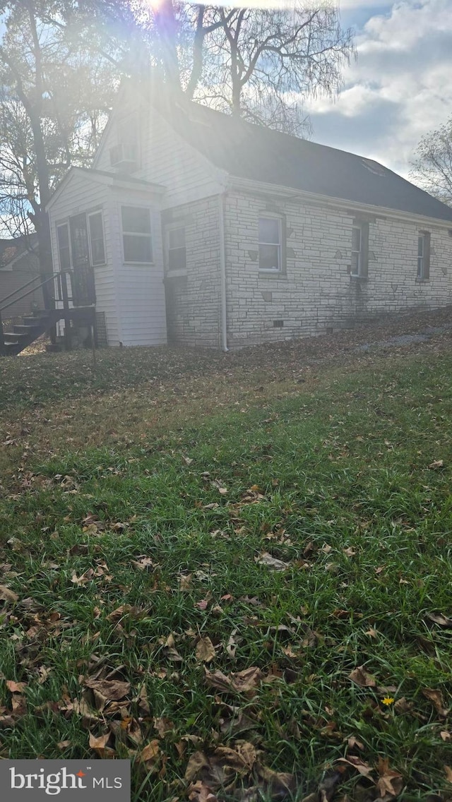 view of side of property with a yard