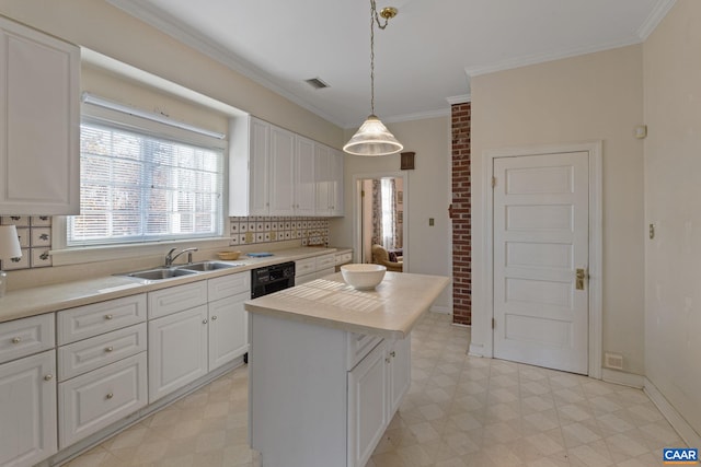 kitchen with white cabinets, pendant lighting, a kitchen island, and sink