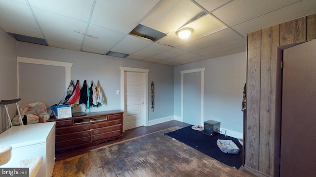 bedroom featuring a paneled ceiling and dark hardwood / wood-style flooring