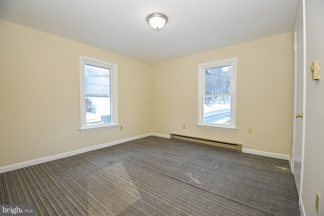 carpeted spare room featuring a baseboard radiator