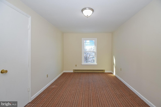 empty room featuring a baseboard radiator and dark carpet