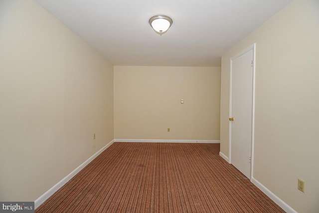 empty room with dark colored carpet