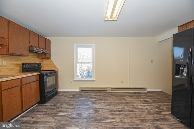 kitchen featuring sink, baseboard heating, dark hardwood / wood-style floors, decorative backsplash, and black appliances