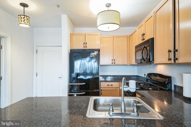 kitchen featuring black appliances, decorative light fixtures, sink, and light brown cabinetry