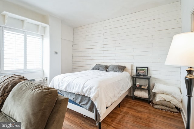 bedroom with dark wood-type flooring